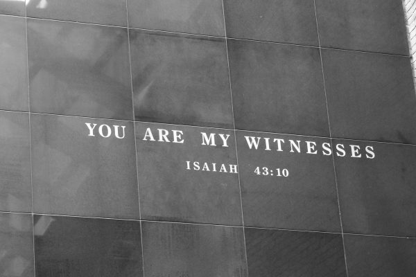 A black and white photo of a quote from Isaiah 43:10, "You are my witnesses," etched into a stone-paneled wall at the United States Holocaust Memorial Museum. Image by hannahlmyers from Pixabay.