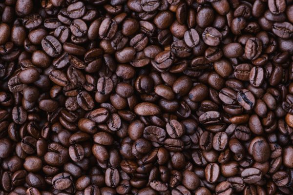 A close-up photograph of dark brown coffee beans. Image via Pixabay.